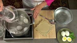 Overhead how to make a boiled cooked egg on the stove with a pan of water. Stock Footage