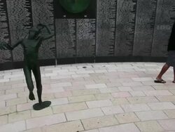 Long shot of tourist looking at list of victims. Stock Footage