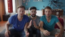 Guys sitting on couch watching tv and cheering Stock Footage