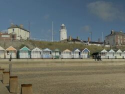 Southwold,colourful beach huts,People walking on promenade,,Lighthouse,MS, Stock Footage