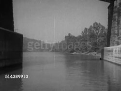 1952: MONONGAHELA RIVER: ALLEGHENY PLATEAU: VS Moving along the Mon river, passing under bridge, passing by 'Nancy Jane' paddle steamer docked along riverbank, & abandoned coal mine tipple along bank. Upstream, riverboat Instructional Video