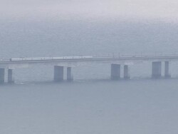WS AERIAL TS ZO Cars and train on Great Belt Bridge / Funen, Denmark Stock Footage