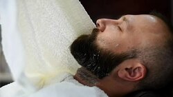 Close-up of beautiful attractive adult man with beard in a barber shop Stock Footage