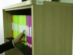 Dolly: Businesswoman finding document from cabinet and reading Stock Footage