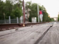 MS Young male and female couple walking and balancing on train track outside in urban area together having fun and smiling / Minneapolis, Minnesota, United States Stock Footage