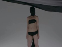 Unidentifiable woman wrapped in black flowing cloth Stock Footage