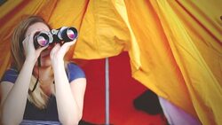 woman traveler looking through binoculars Stock Footage