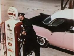 Sinclair gas station attendant starts to pump gas Stock Footage