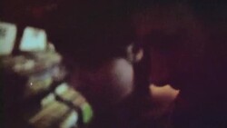 16mm film footage of young couple flipping through vinyl albums in record store Stock Footage