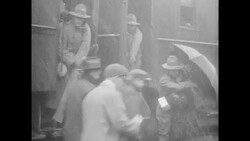 WWI soldier in Detroit kissing woman in sleeting rain as he boards train to go off to war Stock Footage