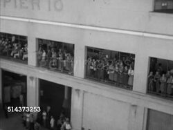 1953: SHIP TO HAWAII: HA MS Cruise ship, ocean liner moving in port, VS People on ship waving, young woman receiving lei (garland) traditional wreath  of flowers from indigenous Hawaiian female, HA WS Tourists w/ leis around necks leaving ship. Instructional Video