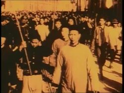 Chinese citizens armed with weapons walk through the street. News Clip