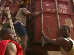 MS Shot of truck with people taking old televisions out of truck / Lagos, Nigeria Stock Footage