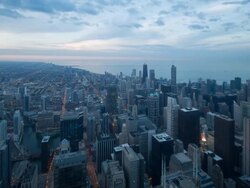 High angle view of Chicago skyline and suburbs looking west in the evening, Chicago, Illinois, USA. Stock Footage