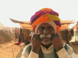 Close-up of a rajasthani senior man adjusting his Moustache, Pushkar, Rajasthan, India Stock Footage