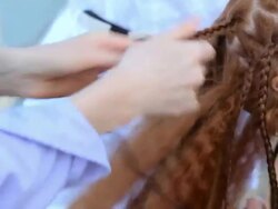 process of unbraid braids on red-haired teenage girl Stock Footage