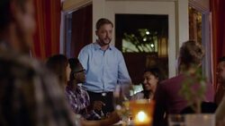 Proud restaurant owner chats with satisfied customers Stock Footage