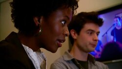 MS ZO R/F TD PAN Two producers standing over editor working at computer in studio/ New York, New York Stock Footage