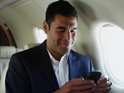 MS Businessman texting in airplane / Spanish Fork, Utah, USA Stock Footage