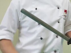 Chef sharpening his knife, UK Stock Footage