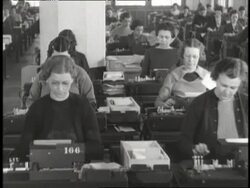 Rows of women work on punch card machines at desks in a large Social Security office. News Clip