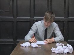 Teenage boy writing, getting frustrated and crumpling paper Stock Footage