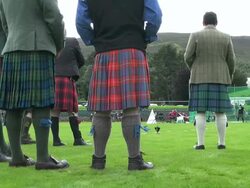 MS Shot of referees standing and man throwing hammer at braemar royal highland games / Braemar, Aberdeenshire, Scotland Stock Footage
