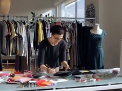 MS Fashion designer working at desk while looking at swatch board / New York City, New York, USA Stock Footage