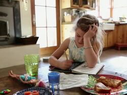 MS Little girl coloring in her colouring book with eating / St. Simon's Island, Georgia, United States Stock Footage