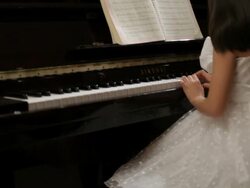 TD TU MS Rear view of girl wearing white dress, playing piano / China Stock Footage