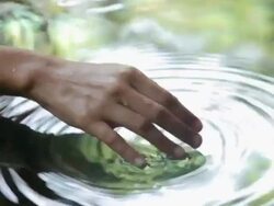Close up of female hand touching water Stock Footage