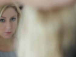 Female in bathroom looking at mirror Stock Footage