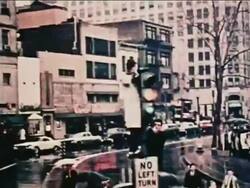 1962 car point of view past man standing on top of sign on traffic light tipping hat at John Glenn in parade Stock Footage