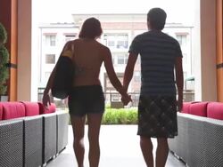 Couple walking through outdoor seating area Stock Footage