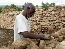 Afar men building stone enclosure Stock Footage