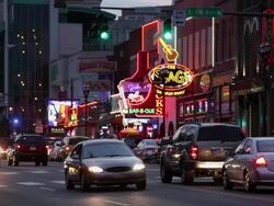 MS Traffic at dusk on street lit with neon signs / Nashville, Tennessee, United States Stock Footage
