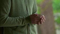 Young Japanese man holding Japanese tea at the temple. Kyoto, Japan. Stock Footage