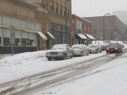 MS Parked cars and people walking on side street during winter / Minneapolis, Minnesota, USA Stock Footage