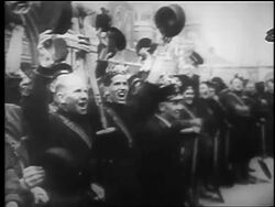 B/W 1940 crowd of men cheer + raise arms with hats in air outdoors after London Blitz / educational Stock Footage