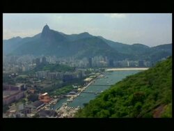 WA Tracking, city and harbour of Rio De Janeiro against mountain horizon and Jesus Christ sculpture, from ascending cable car Stock Footage