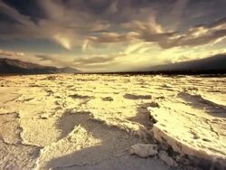 WS LA POV Dry Cracked Earth and Salt Flats / Death Valley NP, California, United States  Stock Footage