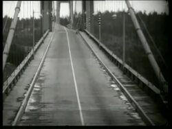 B/W 1940's bridge twisting, swaying + buckling in wind / Galloping Gertie / Tacoma Narrows Bridge / Stock Footage