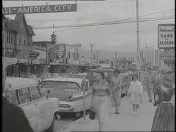 Alaskan citizens walk down a main street. News Clip