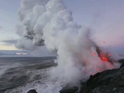 WS Volcano exploding and forming steam cloud by ocean at dawn / Kalapana, Hawaii, USA Stock Footage