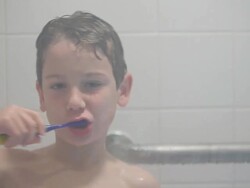 Boy Brushes Teeth in Shower Stock Footage