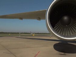 Medium Long Shot static - A blue sky outlines the wing and jet engine of an aircraft at Washington Dulles International Airport. / Washington, D.C., USA Stock Footage