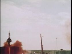 1960s wide shot missile blasting off in cloud of red smoke / Cold War / documentary Stock Footage
