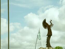 Time lapse "Keeper of the Plains" Native American statue and pedestrian walking bridge, with blue sky and white clouds Stock Footage