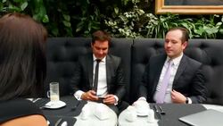 MS Businesswoman passing smartphone to businessman during business meeting at tables in restaurant Stock Footage