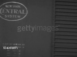 1953: UNION PACIFIC FREIGHT TRAIN:  VS Steam locomotive engine 9031 pulling freight cars out of train yard, freights passing w/ logos on side, heavy smoke from engine chimney, smokestack, conductor Gabe Conant climbing on board caboose, signaling. Instructional Video